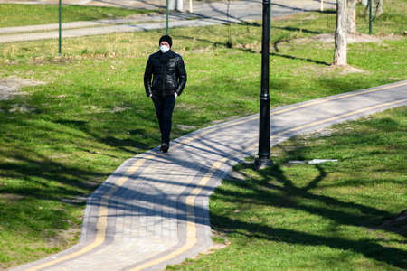 Man wearing protective mask as a preventive measure against the coronavirus COVID 19 on street in...