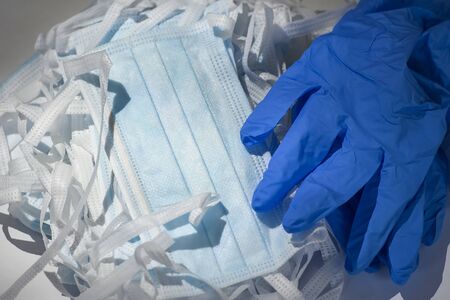 Blue medical protective masks with a filter and blue protective gloves.
