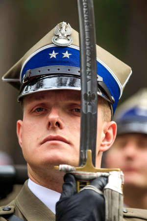 Serviceman of honor guard of Polish army during ceremonial events at Polish military cemetery Polish...