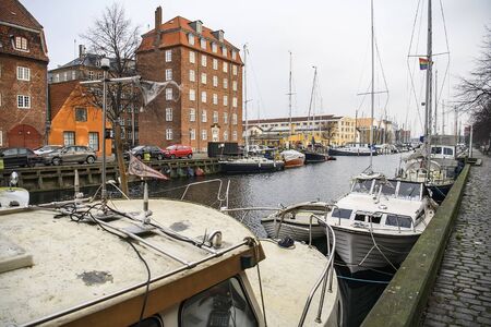 Boats and yachts on canal between Overgaden Oven Vandet and Overgaden Neden Vandet in Copenhagen,...