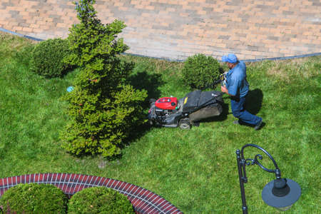 Top view of Lawn Mower operating in the center of Vinnytsia, Ukraine. July 2020. High quality photo