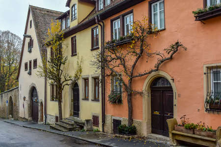 Traditionally trimmed tree on narrow medieval street in old town Rothenburg ob der Tauber, Bavaria, Germany. November 2014の写真素材