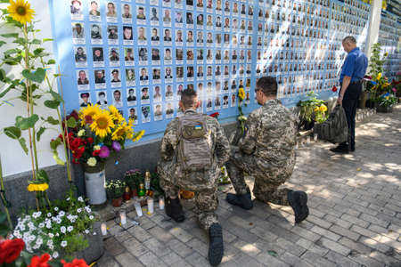 Ukrainian military near Memory Wall of Fallen Defenders of Ukraine in war in Eastern Ukraine...