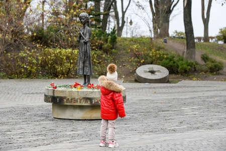 Girl near the monument to the victims of the Holodomor who died of starvation in 1932-33. Kyiv, Ukraine,のeditorial素材