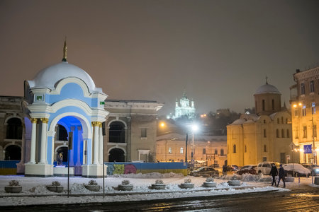 Churches and Historical well fountain Samson and Lion at Kontraktova Square in the Podil district in...