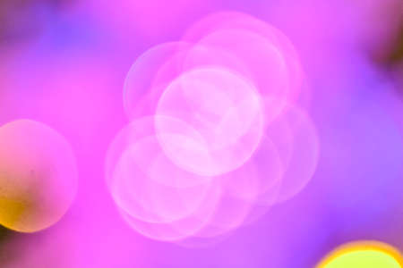 Multicolored holiday lights in defocus. Blurred abstract illuminate decorative lights with bokeh in night background. High quality photoの写真素材