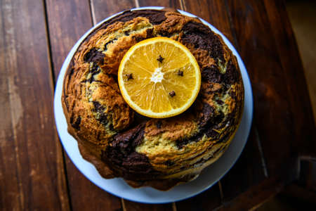 Homemade chocolat-orange cake decorated with orange slice on a dark wood background. High quality photoの写真素材