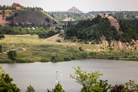 View to large waste heap of coal mine and Kalmius river in Donetsk, Ukraine. June 2012. High quality photoの写真素材
