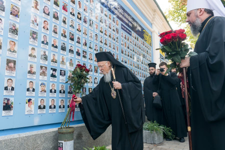 Ecumenical Patriarch Bartholomew carries flowers to Memory Wall of the Fallen Defenders of Ukraine...