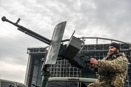 Member of the mobile air defence group checks a DShK machine gun atop of a pick up truck in the...