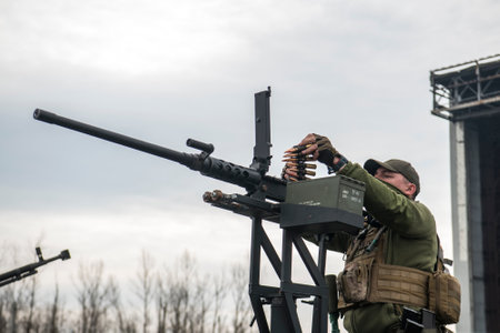 Member of the mobile air defence group checks a DShK machine gun atop of a pick up truck in the Hostomel town, Ukraine, April 1, 2023. High quality photoのeditorial素材