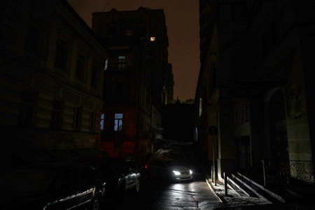 Dark streets and houses during a blackout caused by massive missile attacks on Ukraines energy infrastructure in Kyiv, Ukraine, on December 2024. High quality photoの写真素材