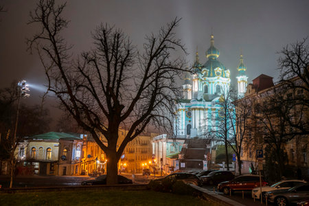 Evening view to St. Andrew Church and Andriyivskyy Uzviz Descent Street in Kyiv, Ukraine February 21, 2025. High quality photoの写真素材