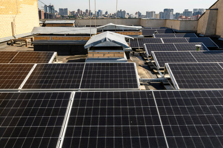 Solar panels installed on the rooftop of a residential building, with a skyline of modern...