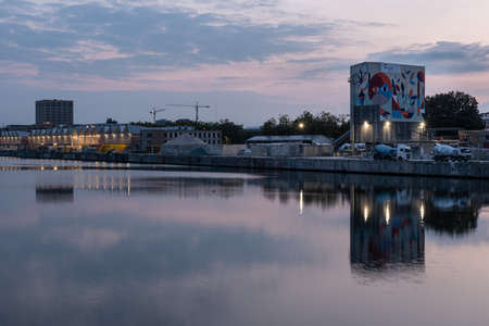 Laeken, Brussels Capital Region, Belgium - 09 10 2021: Industrial buildings at the banks of the canal at duskのeditorial素材