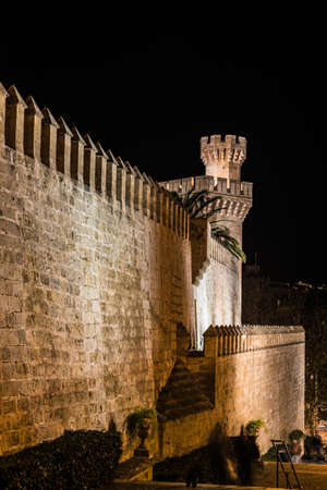 Palma de Mallorca, Mallorca - Spain - 12 28 2017: Historical fortress wall and tower in old town by nightのeditorial素材