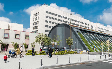 Jette, Brussels - Belgium - 04 28 2019 - Patients and visitors walking around the main entrance of the UZ Brussels, the university hospital at the Brussels medical campusのeditorial素材