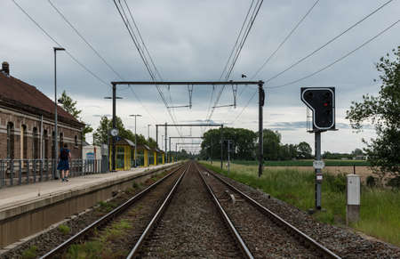 Heizijde, Flanders Belgium - 05 25 2020 Empty railway tracks and platform of the Heizijde station at the Belgian countrysideのeditorial素材
