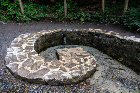 Oud-Heverlee, Flemish Brabant, Belgium - 08 2 1 2022 - Spiral stones of a natural water sourceの写真素材