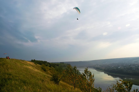 Extreme fly above the river on paraglider
