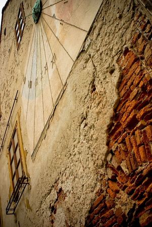ancient sundial on the yellow stucco wall in Zagreb, Croatiaの写真素材
