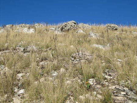 Stony hill on a background blue sky.の写真素材