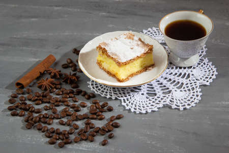Cake with a cup of coffee with coffee beans and cinnamon and aniseの写真素材
