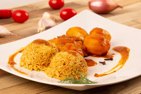 Rice, potatoes with chicken in curry sauce.の写真素材