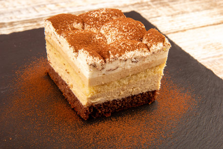 Tiramisu cake on a stone base.