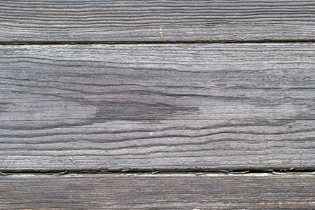 Gray board, wood texture, wooden background, damaged, cracked.の写真素材