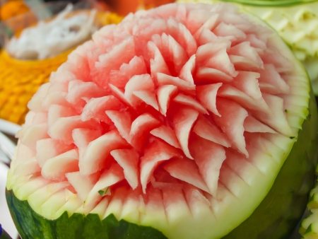 Watermelon carvings on a plate and famous tropical fruits cut professionallyの写真素材