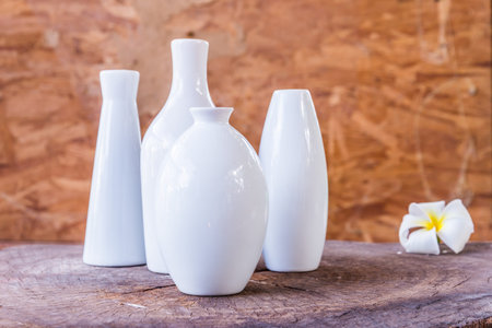 porcelain vases of various shapes on wood backgroundの写真素材