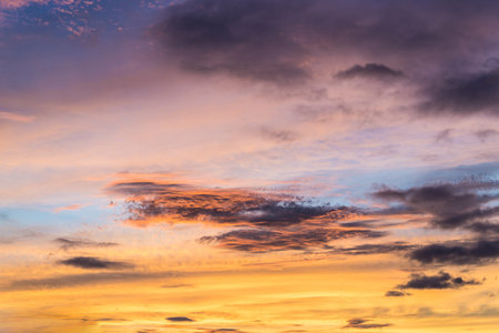 Dramatic sunset sky with orange colored clouds.