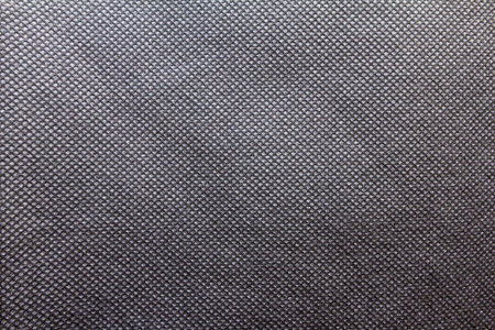 Black spunbond fabric. black nonwoven polypropylene fabric texture background. Full frame shot of...