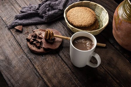 Guatemalan style handmade chocolate drink on old wooden table natural ingredients and integral...
