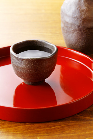 Sake served on red tray の写真素材