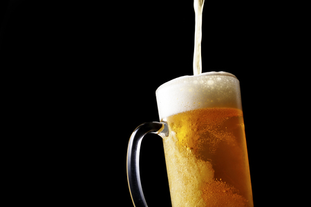 Pouring beer into glassの写真素材