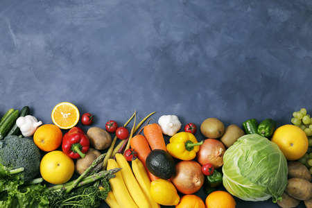 Set of different fruits and vegetables line on dark backgroundの写真素材