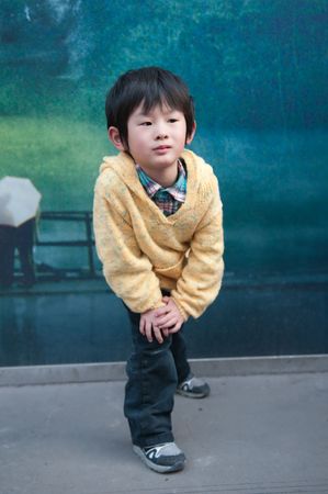 Street-side billboards in front of a little boyの写真素材