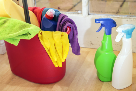 Cleaning products in a dirty kitchenの写真素材