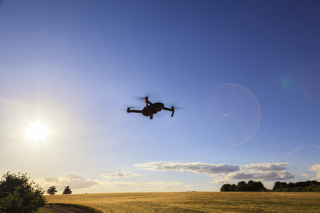 Flying drone above the wheat field. Drone in the airの写真素材