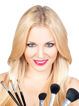 Beautiful woman with makeup brushesの写真素材