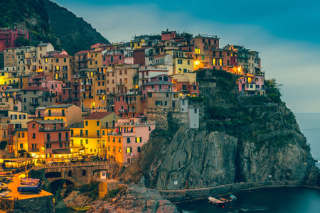 Town on the rocks at night Liguria Italy