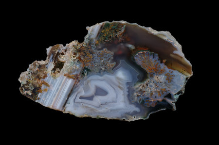 Agate. A cross section of the stone on a black background. Origin: Poland, Rudno near Krakow....