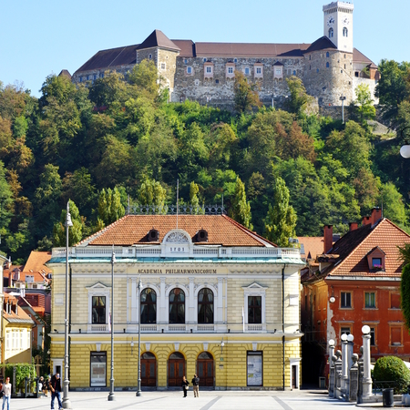 Ljubljana, Slovenia, September 25, 2016 City Center, Congress Square - Slovenian Philharmonic. In the background on the hill is visible the Ljubljana Castle.のeditorial素材