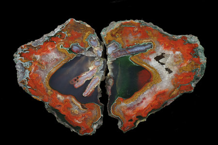 A cross section of the agate stone. Red agate with hematite surrounds pseudomorphs after...