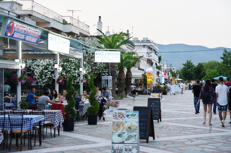 Asprovalta, summer resort in northern Greece on the Aegean Sea. Street in the evening. Visited numerous shops, taverns and strolling tourists.のeditorial素材