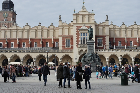 Krakow, Poland - March 11, 2018: Main Market Square, Cloth Hall. At the front is a statue of Adam Mickiewicz, on the back you can see the old town hall tower.You can see a lot of walking tourists.のeditorial素材