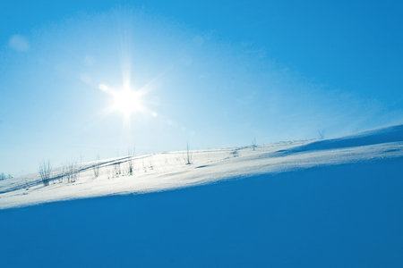 snow slope in the shade of a bright winter day