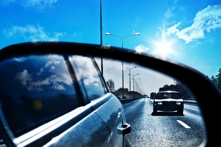 catching the car on the highway, in the rearview mirrorの写真素材